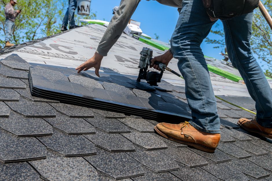 Worker repairing a roof
